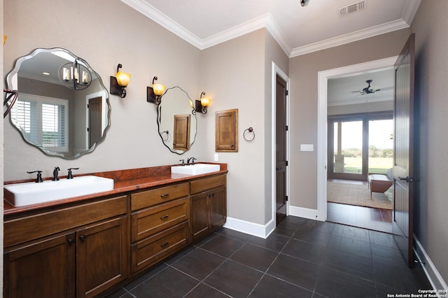 bathroom with tile patterned flooring, vanity, ceiling fan with notable chandelier, and ornamental molding