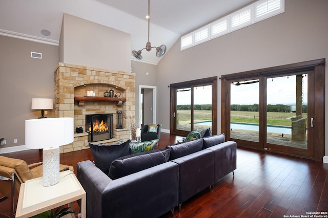 living room featuring a fireplace, crown molding, dark wood-type flooring, and high vaulted ceiling