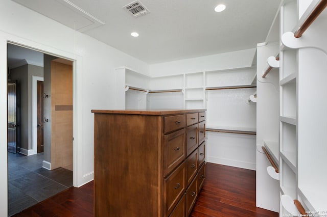 spacious closet with dark hardwood / wood-style floors