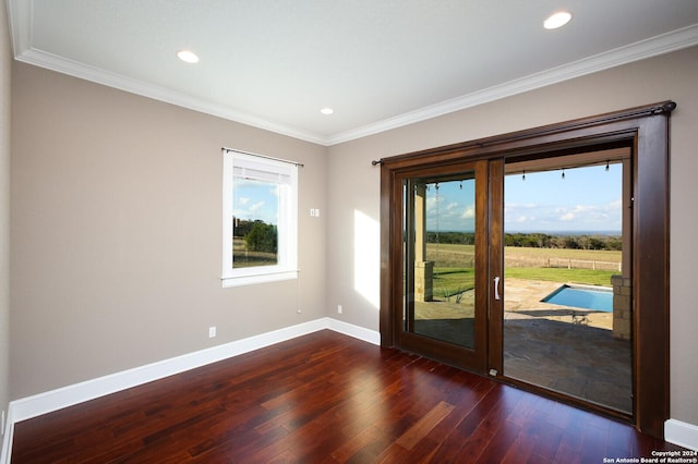 doorway to outside with dark hardwood / wood-style flooring, plenty of natural light, and ornamental molding