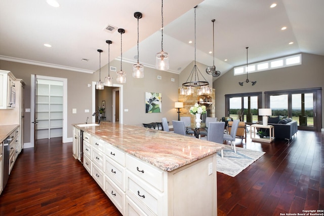 kitchen with white cabinets, dark hardwood / wood-style floors, a spacious island, and hanging light fixtures