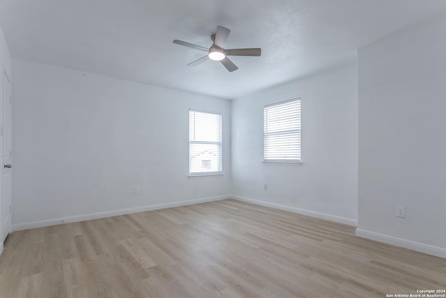 spare room with light hardwood / wood-style floors and ceiling fan