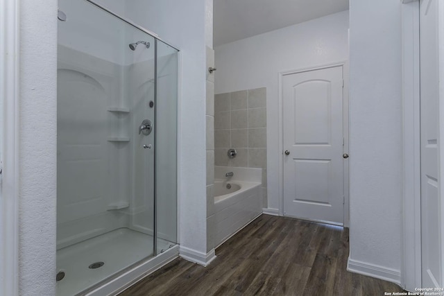 bathroom with plus walk in shower and wood-type flooring