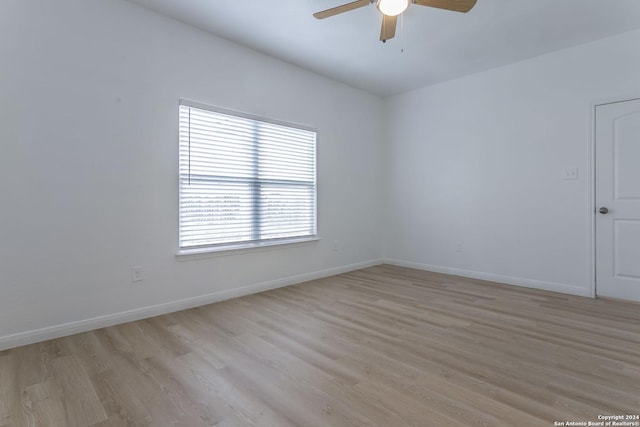 empty room featuring ceiling fan and light hardwood / wood-style flooring