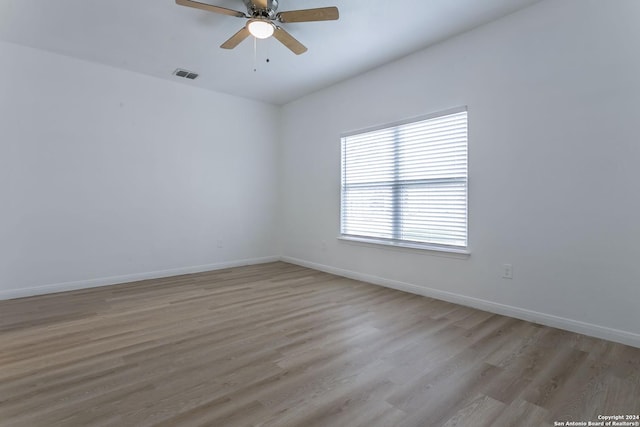 unfurnished room with ceiling fan and light wood-type flooring