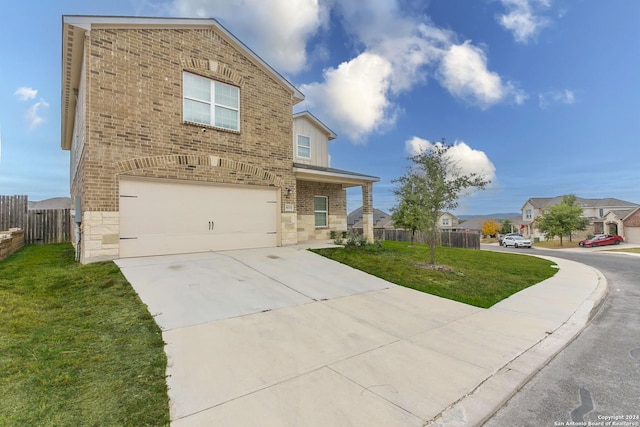 view of front of house with a front yard and a garage