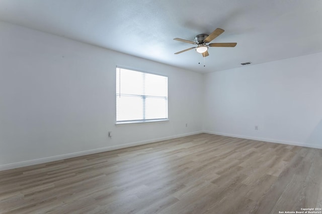 spare room with ceiling fan and light hardwood / wood-style flooring