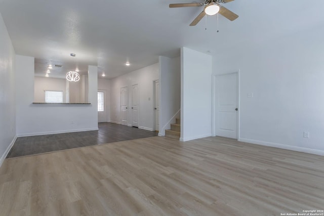 unfurnished living room with ceiling fan and light hardwood / wood-style floors