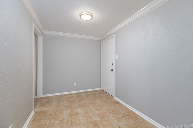 empty room with a textured ceiling and ornamental molding