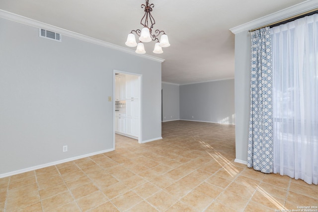 empty room featuring an inviting chandelier and crown molding