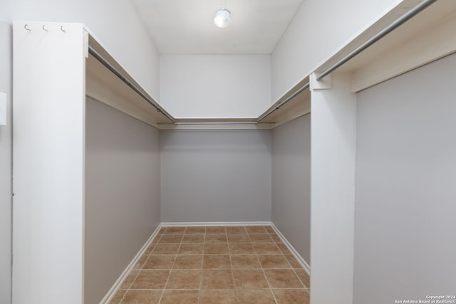 spacious closet with light tile patterned flooring