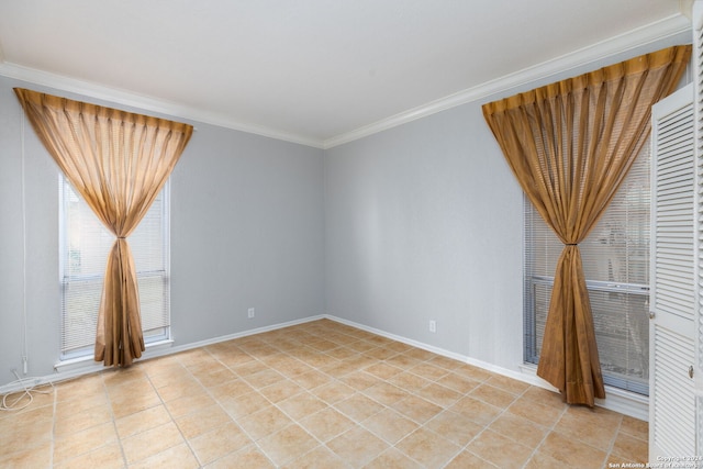 tiled empty room featuring crown molding