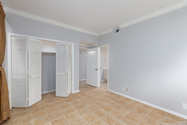 unfurnished bedroom with ornamental molding and light tile patterned floors