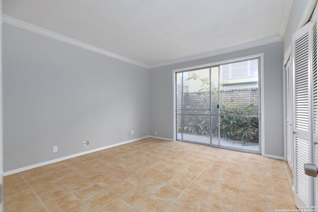 tiled spare room featuring crown molding