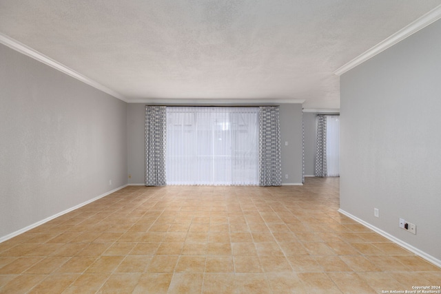 spare room with ornamental molding and a textured ceiling