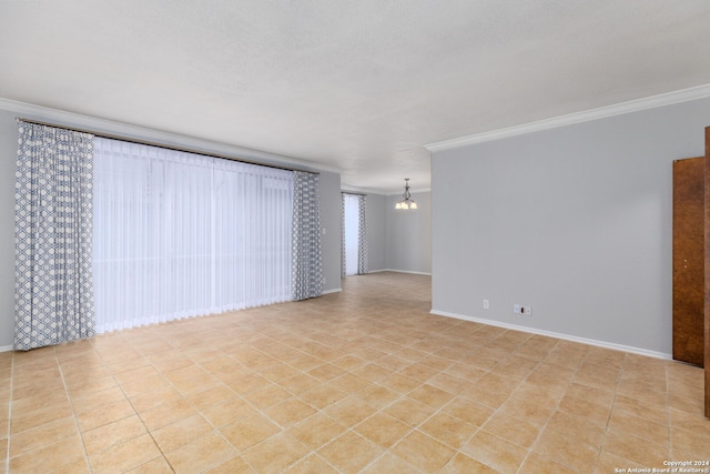 empty room with crown molding and a chandelier