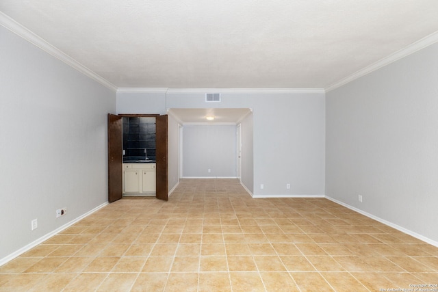 unfurnished living room with crown molding