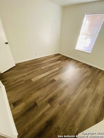 empty room featuring dark wood-type flooring