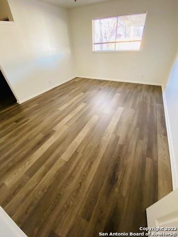 unfurnished room featuring dark hardwood / wood-style floors