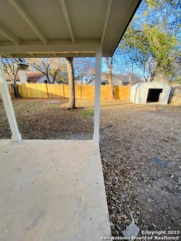 view of yard featuring a patio area and an outdoor structure