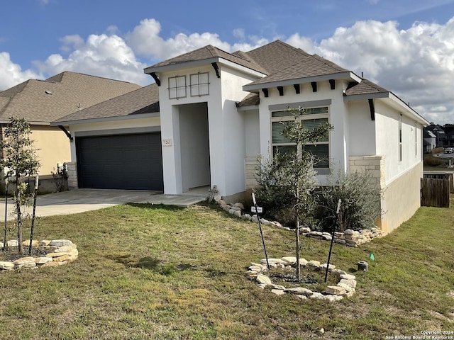 view of front facade with a garage and a front lawn