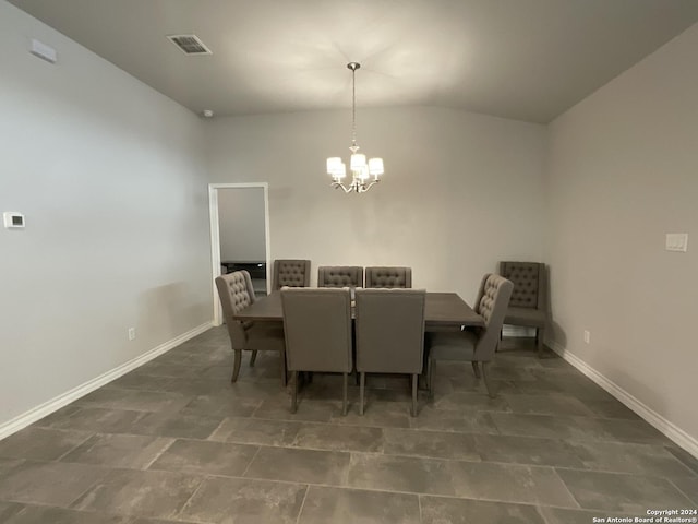 dining area featuring a chandelier and lofted ceiling