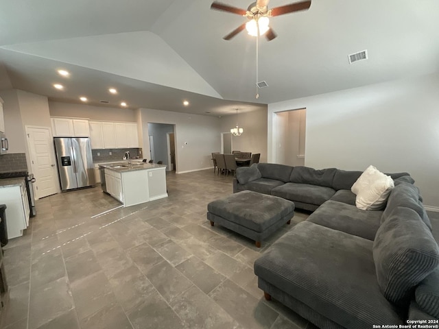 living room with ceiling fan with notable chandelier, sink, and high vaulted ceiling