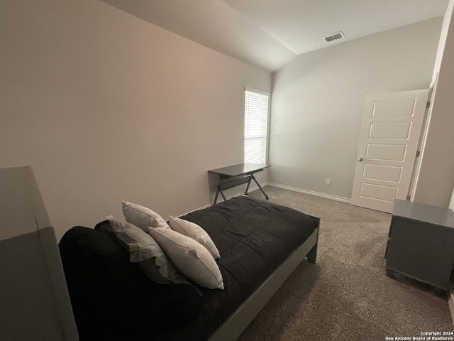 carpeted bedroom with vaulted ceiling