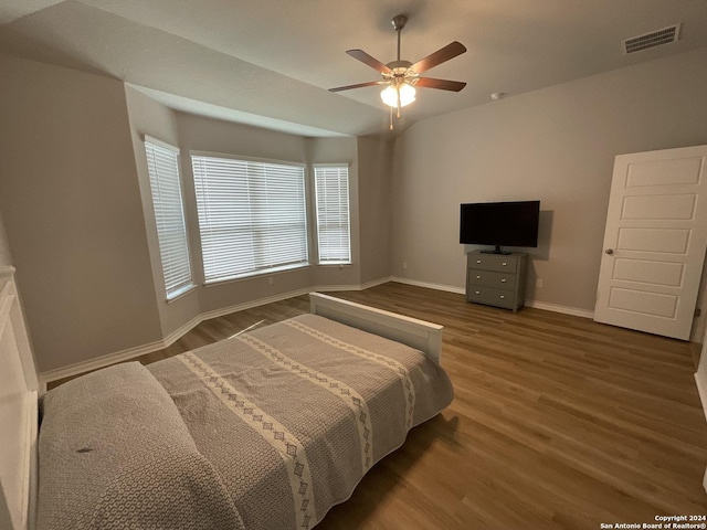 bedroom with ceiling fan and dark wood-type flooring