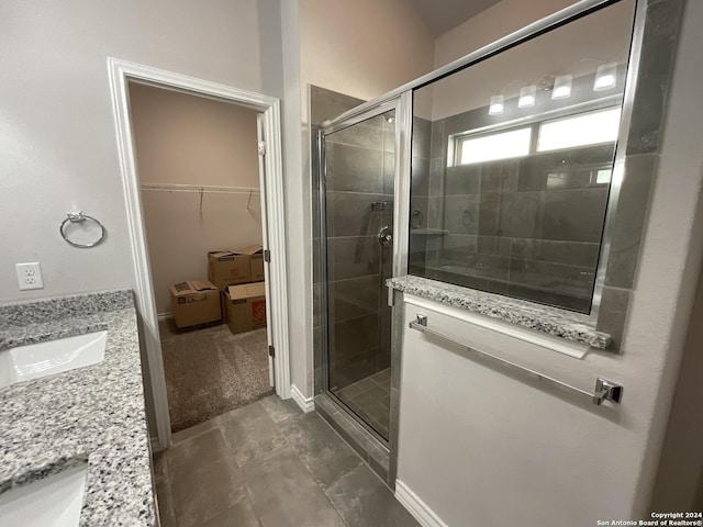 bathroom with tile patterned floors, vanity, and a shower with shower door