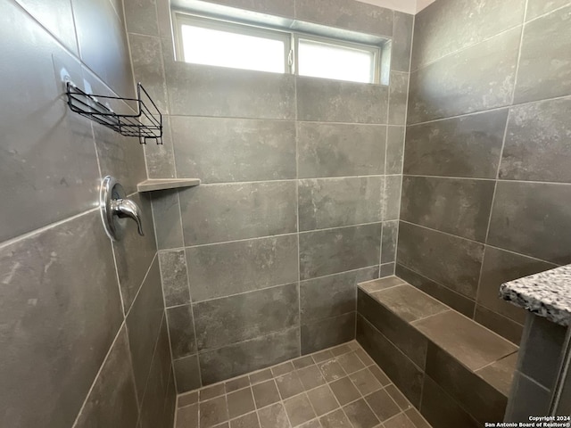 bathroom with tiled shower