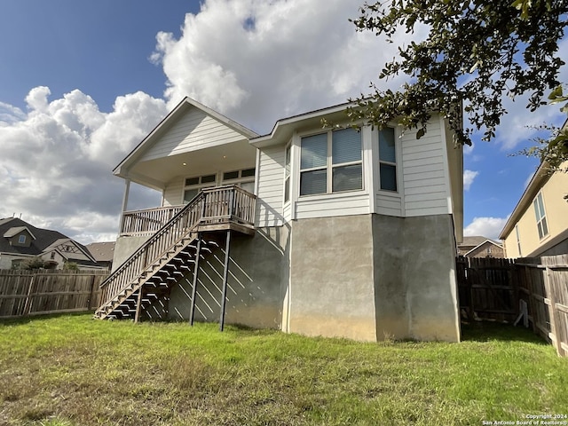 rear view of house with a lawn