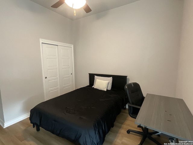 bedroom featuring hardwood / wood-style floors, a closet, and ceiling fan