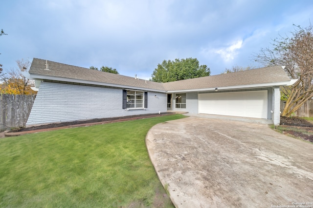 ranch-style home with a front yard and a garage