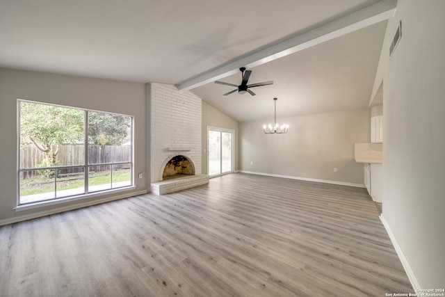 unfurnished living room featuring lofted ceiling with beams, light hardwood / wood-style floors, ceiling fan with notable chandelier, and a brick fireplace