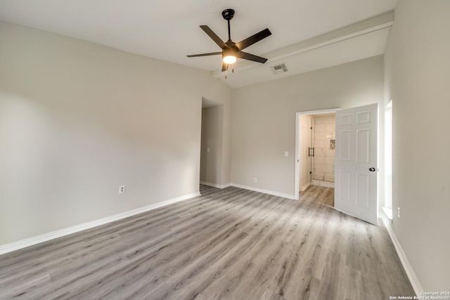 unfurnished room featuring ceiling fan, light hardwood / wood-style floors, and vaulted ceiling