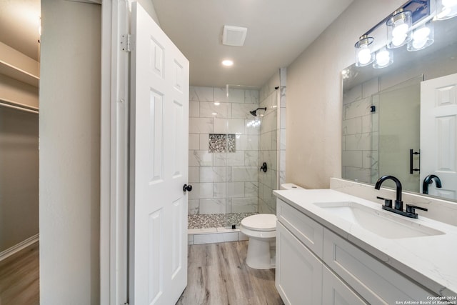 bathroom with toilet, an enclosed shower, wood-type flooring, and vanity