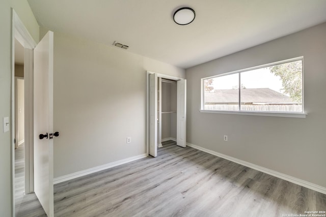 unfurnished bedroom featuring light wood-type flooring