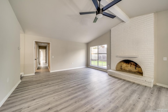 unfurnished living room with lofted ceiling with beams, ceiling fan, light wood-type flooring, and a fireplace