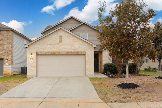 view of front of home featuring central AC unit and a garage