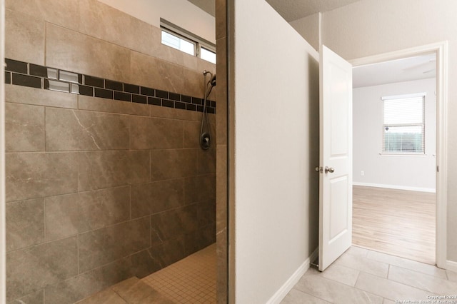 bathroom featuring hardwood / wood-style floors and tiled shower