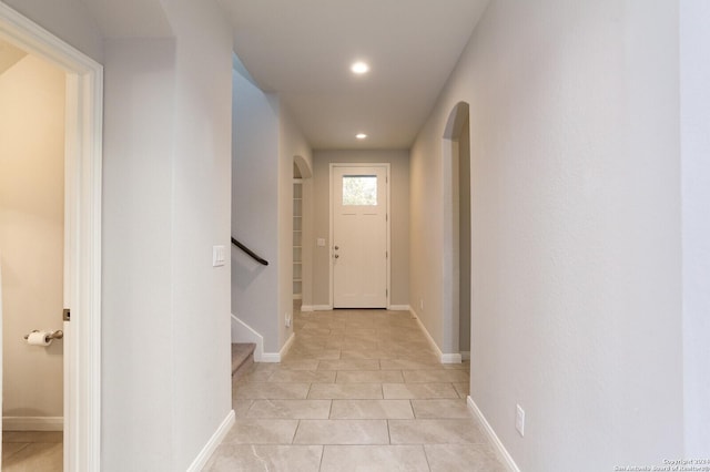 doorway with light tile patterned floors