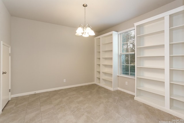 empty room with a notable chandelier