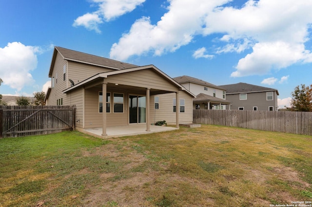 rear view of property with a patio area and a yard