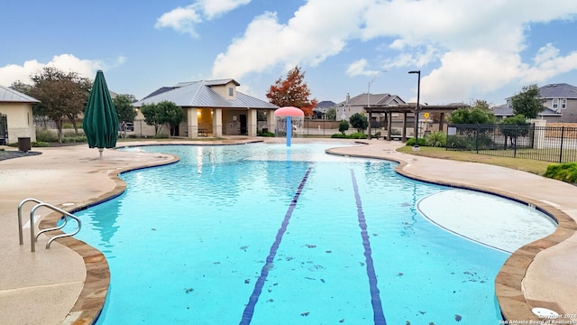 view of pool with a patio and pool water feature