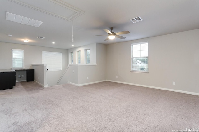 carpeted empty room featuring ceiling fan