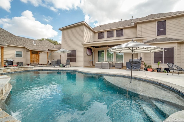 view of swimming pool featuring outdoor lounge area, a grill, and a patio area