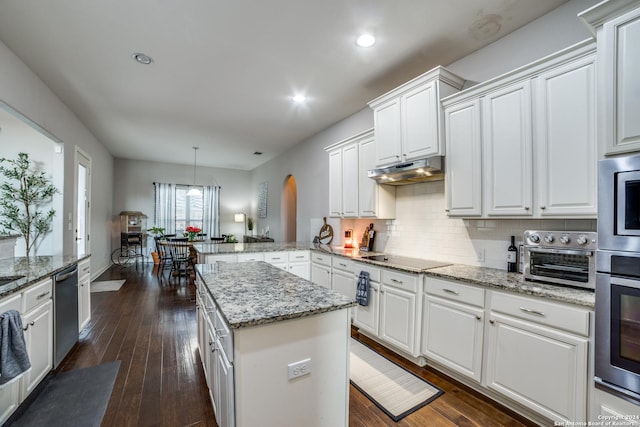 kitchen featuring pendant lighting, white cabinets, kitchen peninsula, and dark wood-type flooring