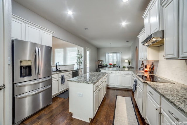 kitchen featuring kitchen peninsula, appliances with stainless steel finishes, dark hardwood / wood-style floors, and white cabinetry