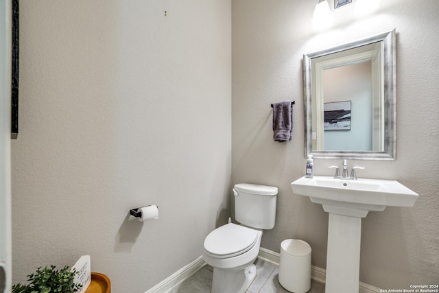 bathroom featuring sink, tile patterned flooring, and toilet